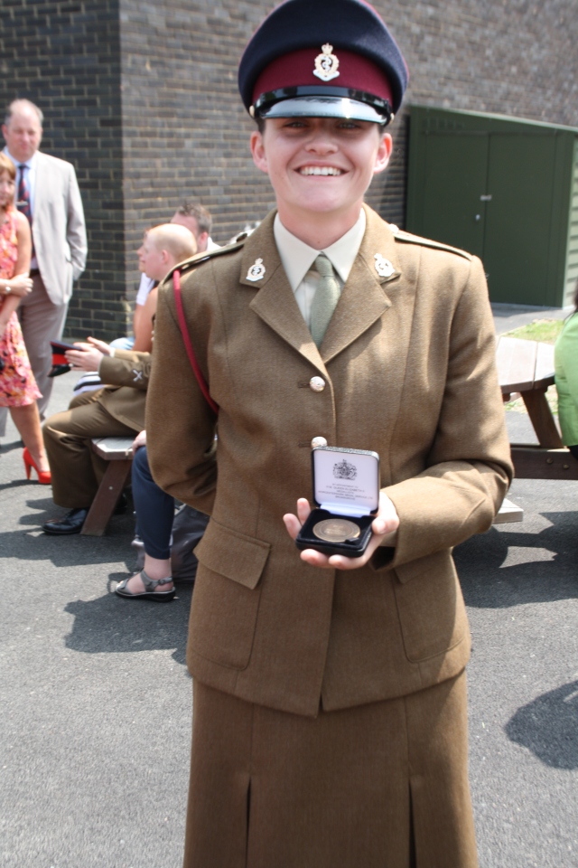 Proud, so very proud of her. She is holding a medal she was awarded for attaining the best fitness in the troop.